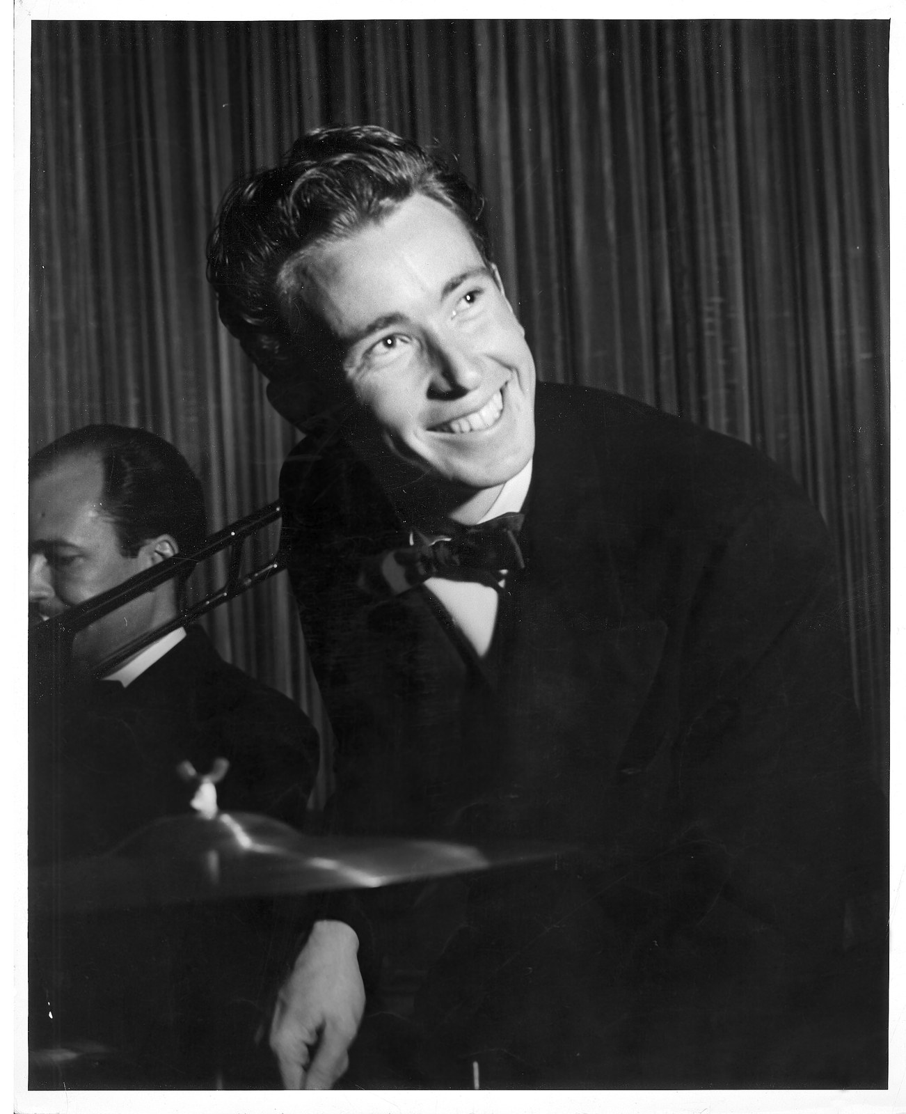 Jazz drummer Dave Coleman playing drums in a tuxedo with a big band