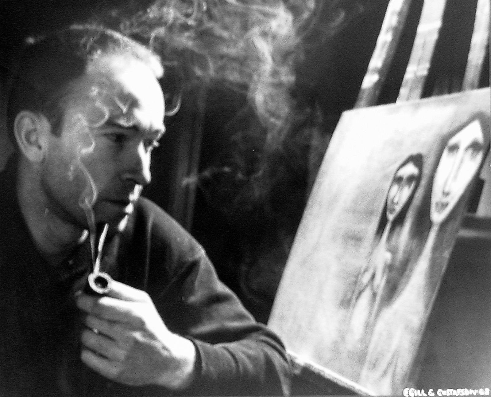 Dave Coleman painting at an easel with a pipe in 1968