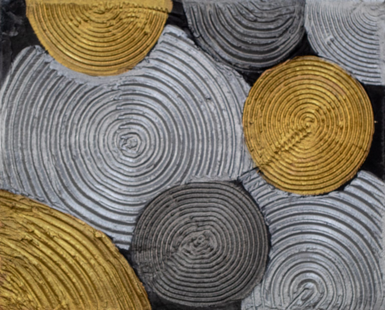 Abstract acrylic painting of silver and gold textured spirals on a near-black background