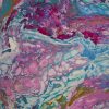 Acrylic pour painting swirled in pink, teal, blue, and purple with cells
